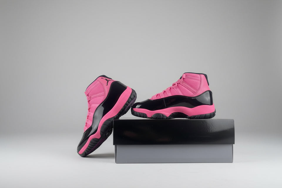 Pink and black sneakers on a gray surface with a white background