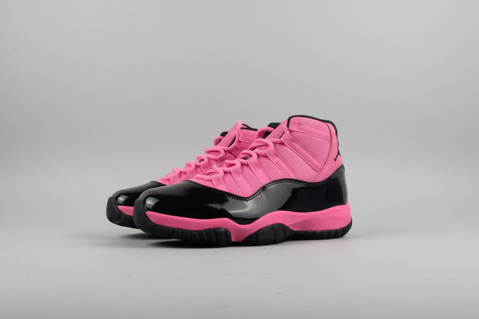 Pink and black sneakers on a gray surface with a white background