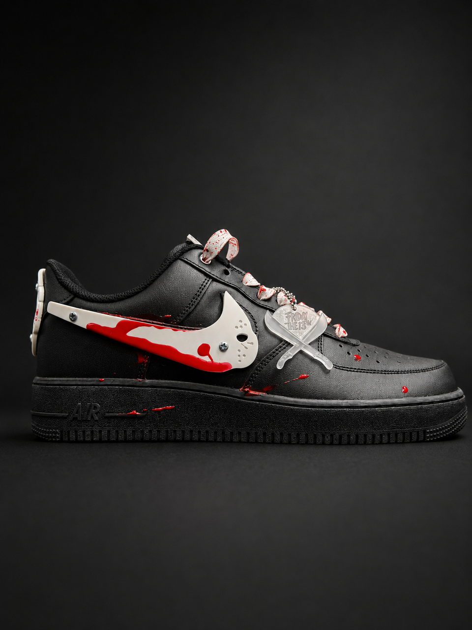 A black Nike Air Force 1 Low sneaker with a horror-themed design, featuring a white Swoosh and cross details splattered with red blood-like paint, set against a dark background.